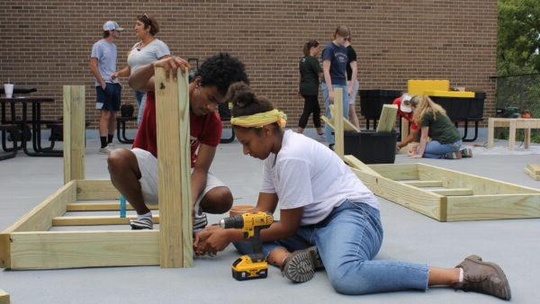 a group of people working on a wood structure